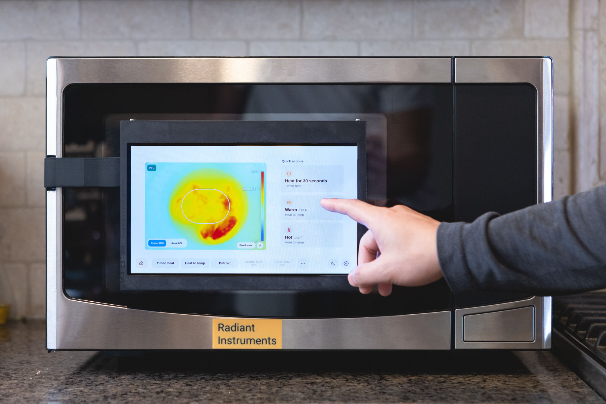 Radiant Microwave prototype showing the touchscreen thermal view in a kitchen.